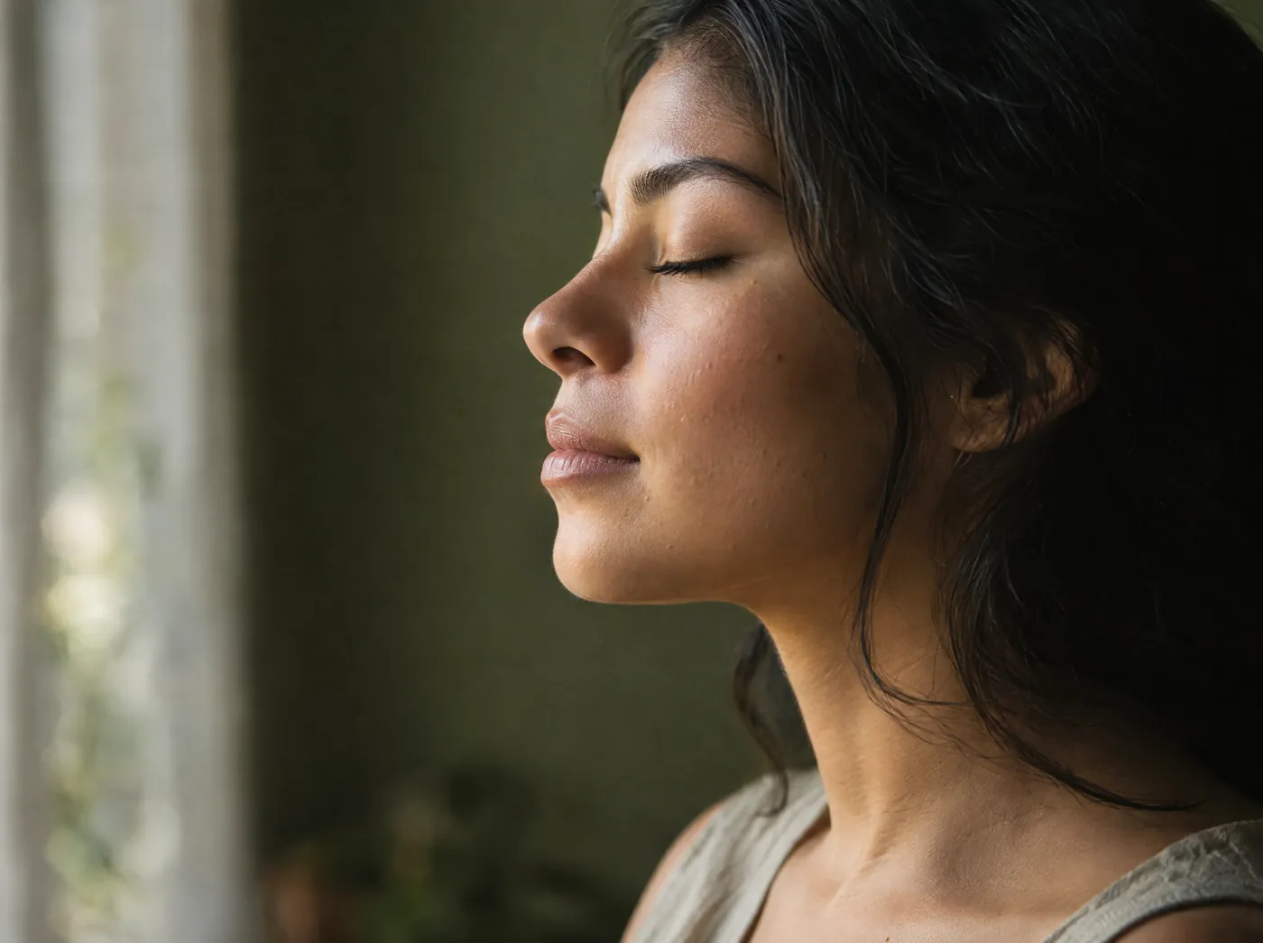 Soft window light on a woman’s cheek